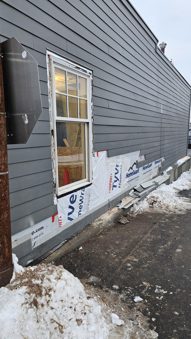 New window set, house wrap and siding going on