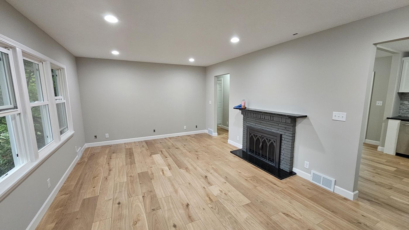 Finished living room: hardwood, recessed lighting, fireplace