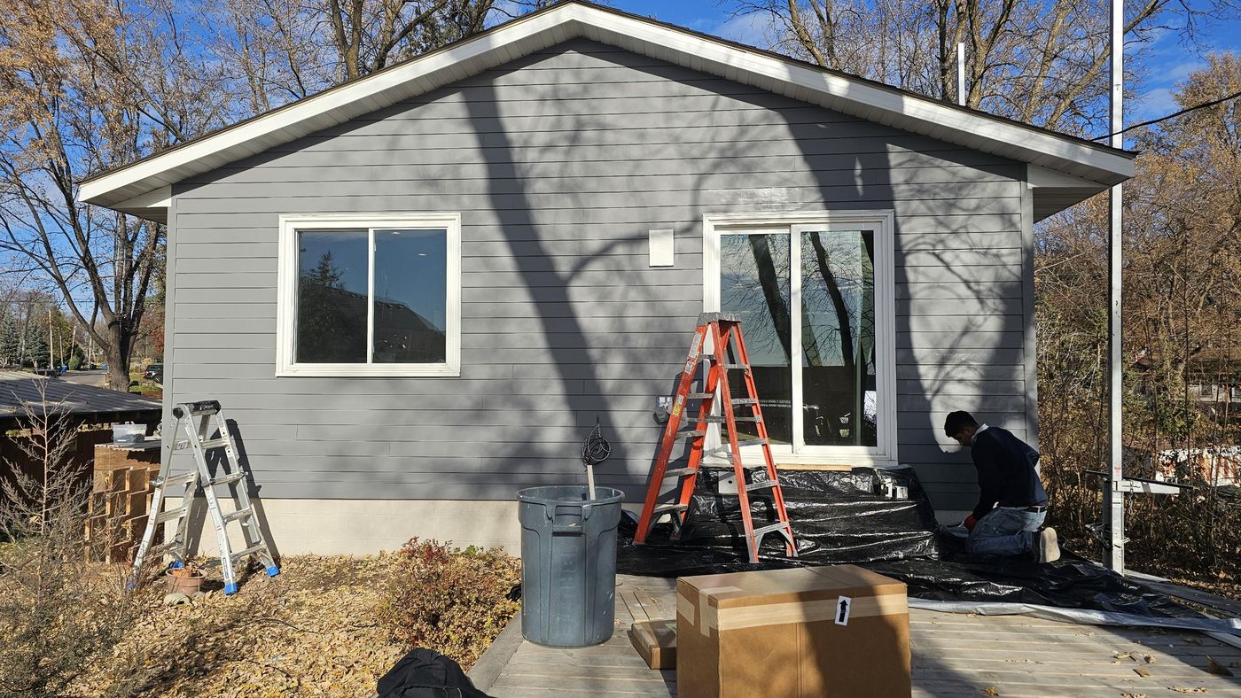 After: rear elevation, new siding and window trim
